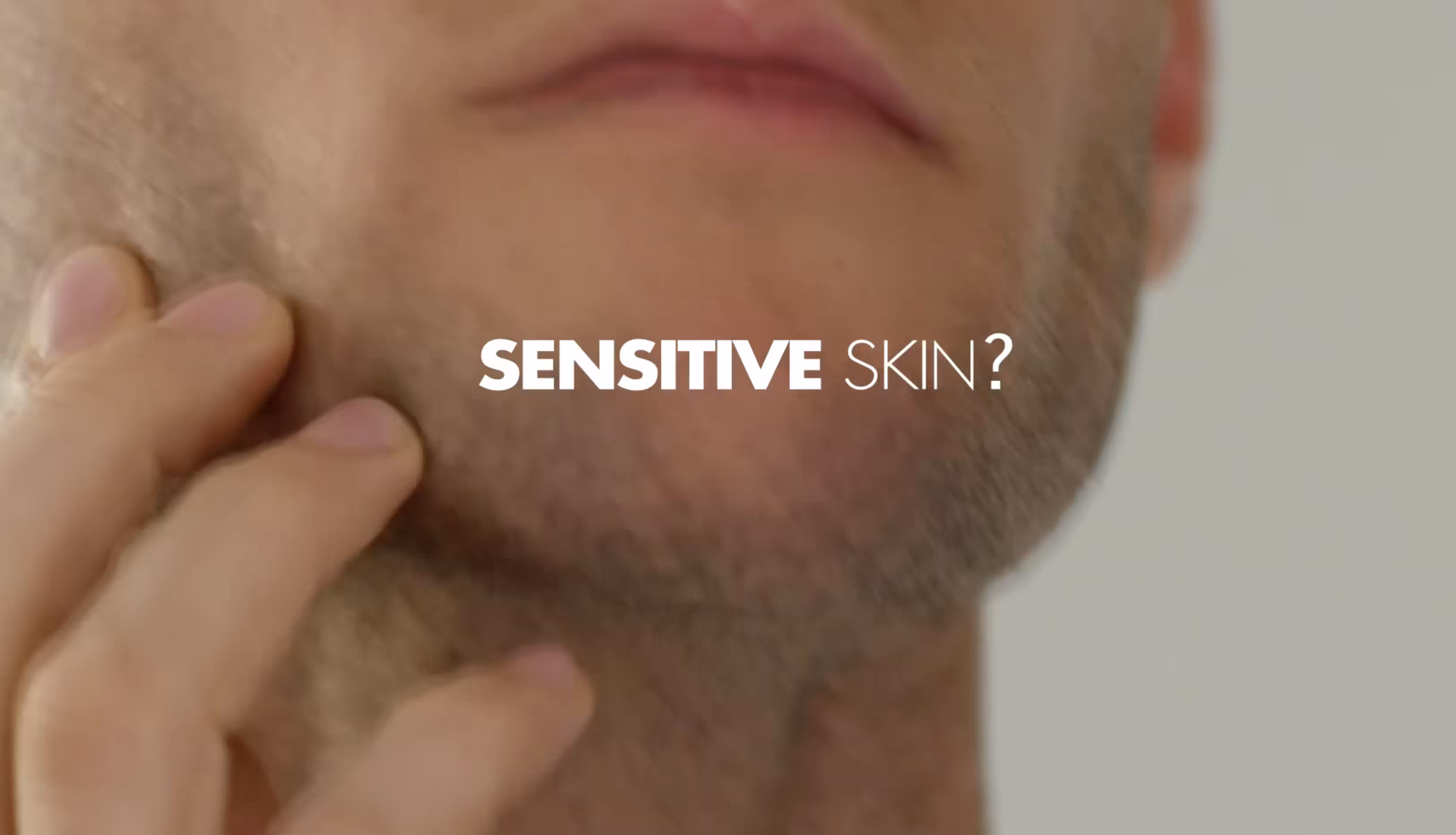 Close-up of a man touching his cheek with text reading “Sensitive Skin?”