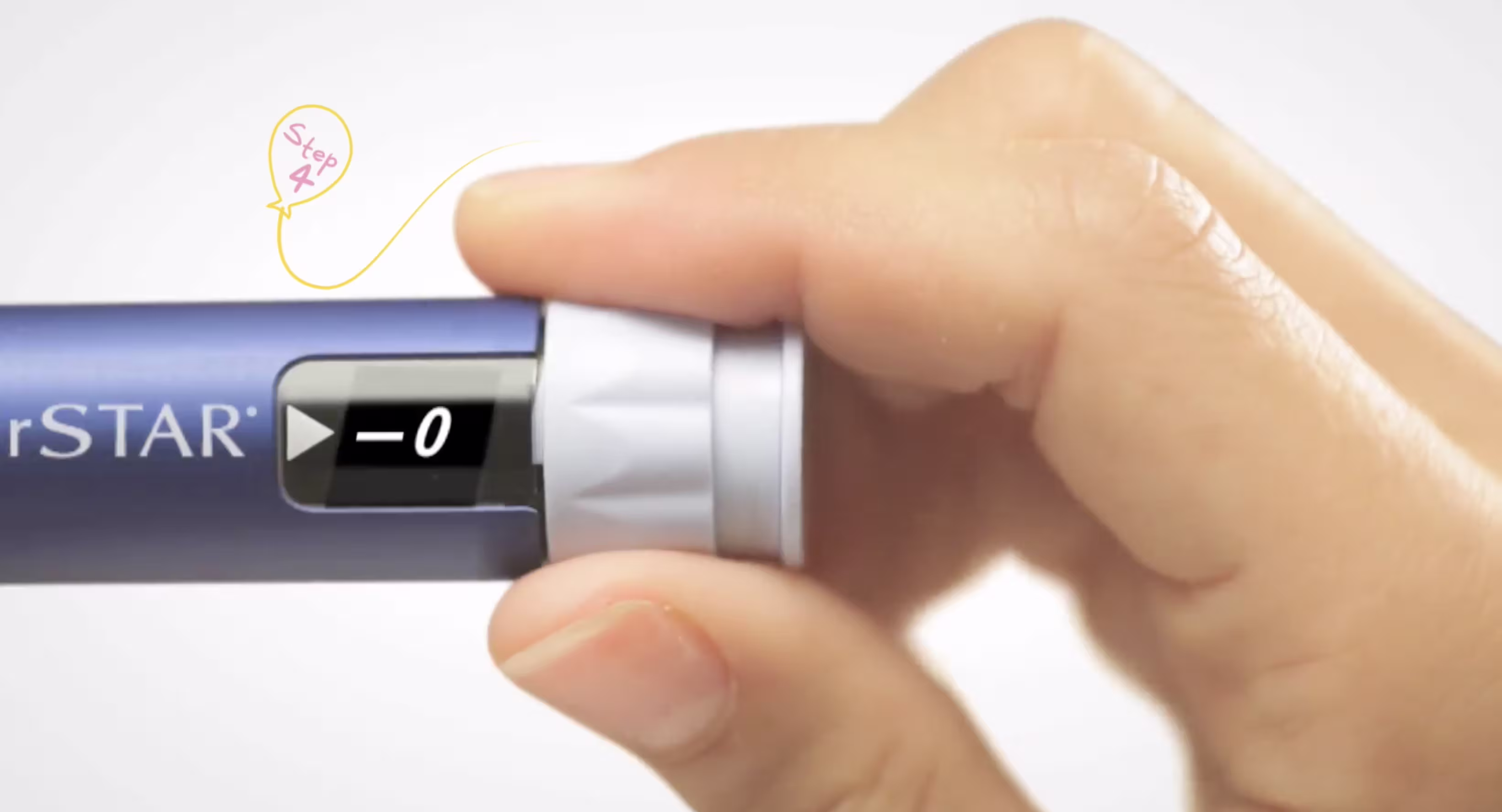 Close-up of a hand turning the dosage dial on an insulin pen, displaying a dose setting in the window.